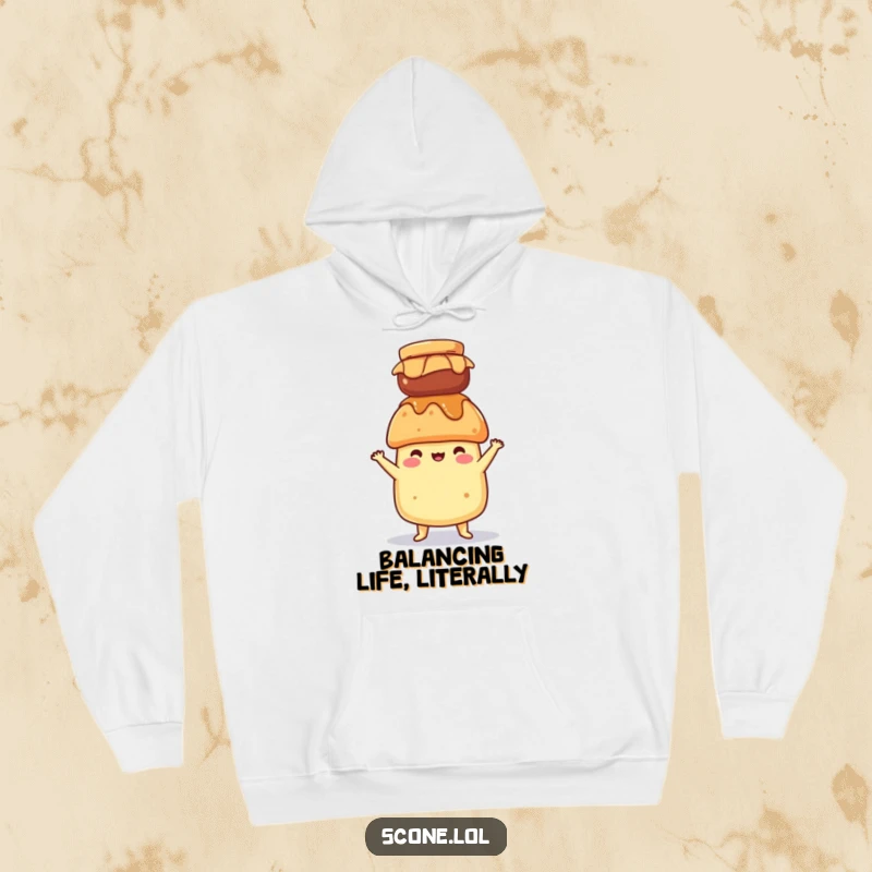 Funny hoodie featuring a scone character balancing a jam jar on its head, offering cozy comfort and humorous stability.
