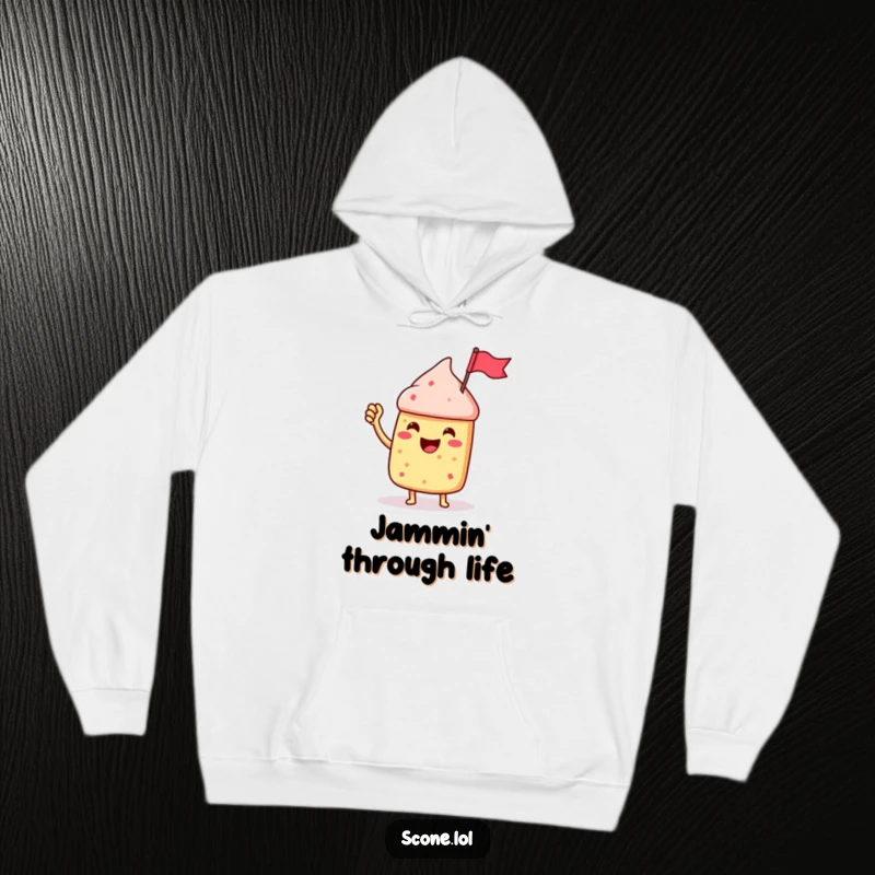 Funny Scone Character Hoodie, enthusiastically waving a tiny jam jar flag, embodying pure, sweet celebration.